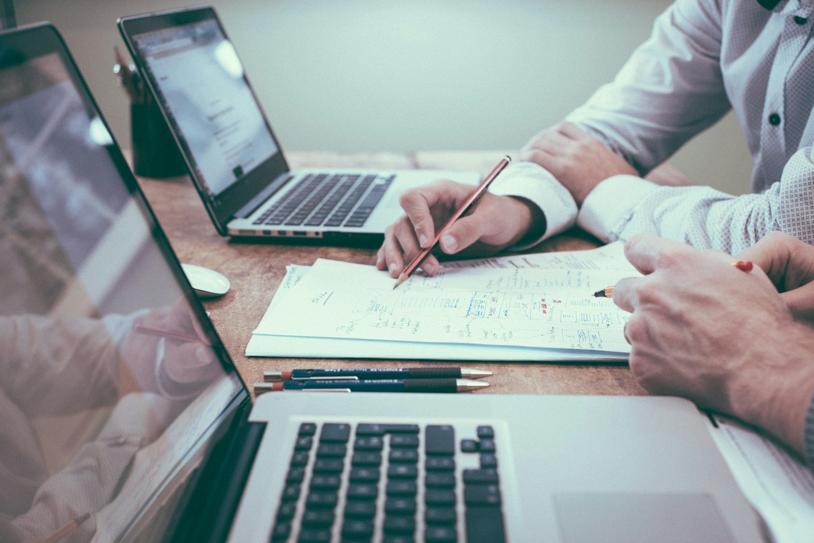 Workforce planning at a desk with laptop and notes